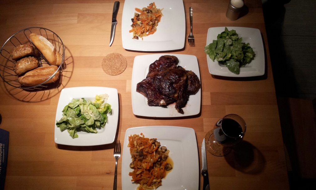 Steaks, Gemüse, Salat und Brötchen